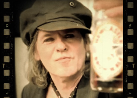 Spike Quireboys with a bottle of Newcastle Brown Ale